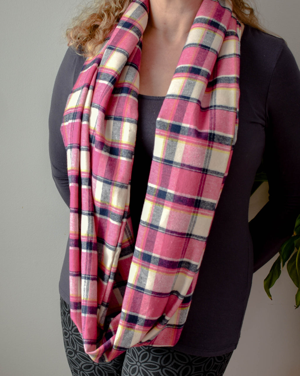 woman wearing pink plaid scarf